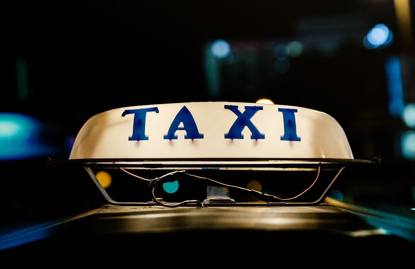 Illuminated taxi roof sign at night