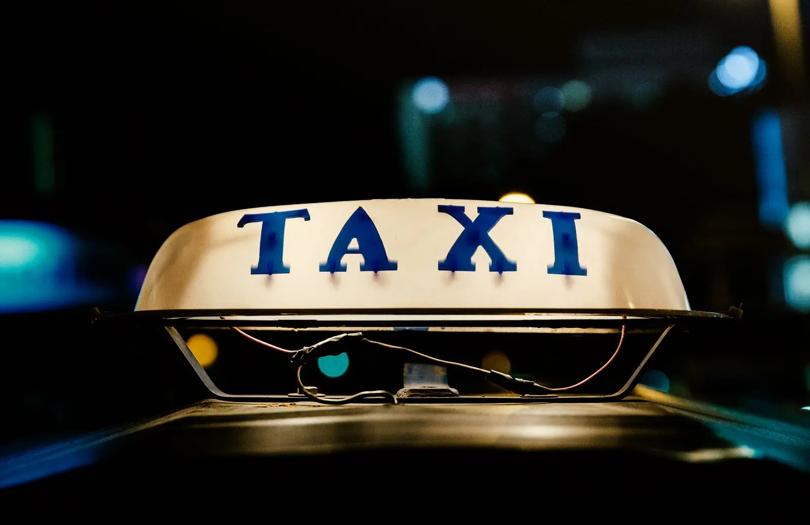 Illuminated taxi roof sign at night